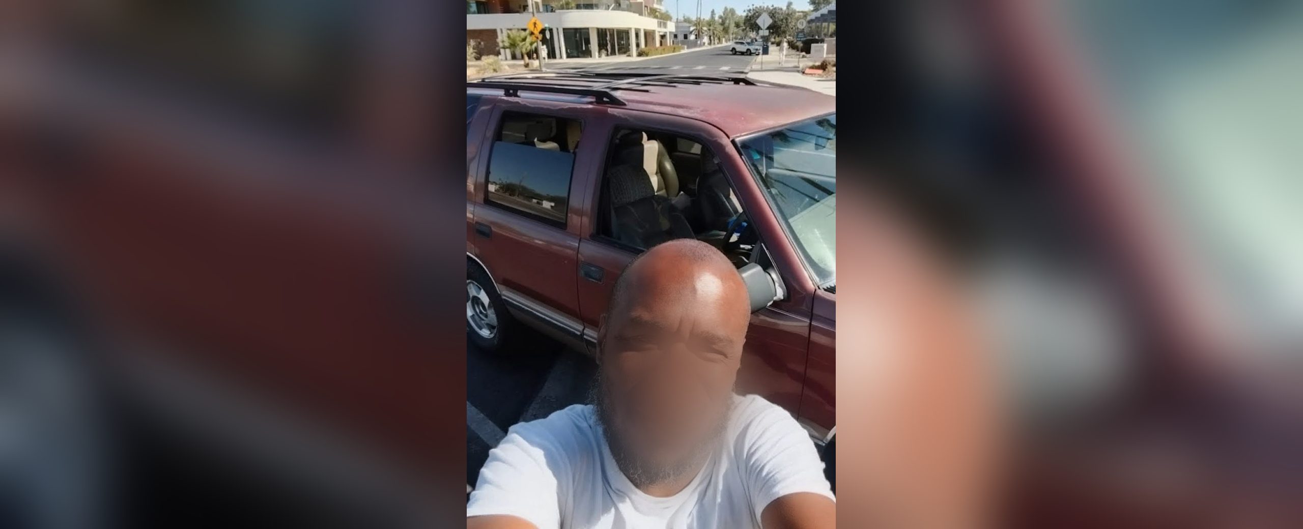 A recipient standing beside the SUV he received through the Automobile Program